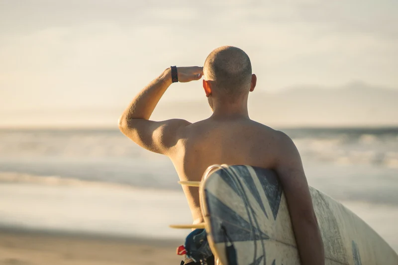 A Man Holding a Surfboard