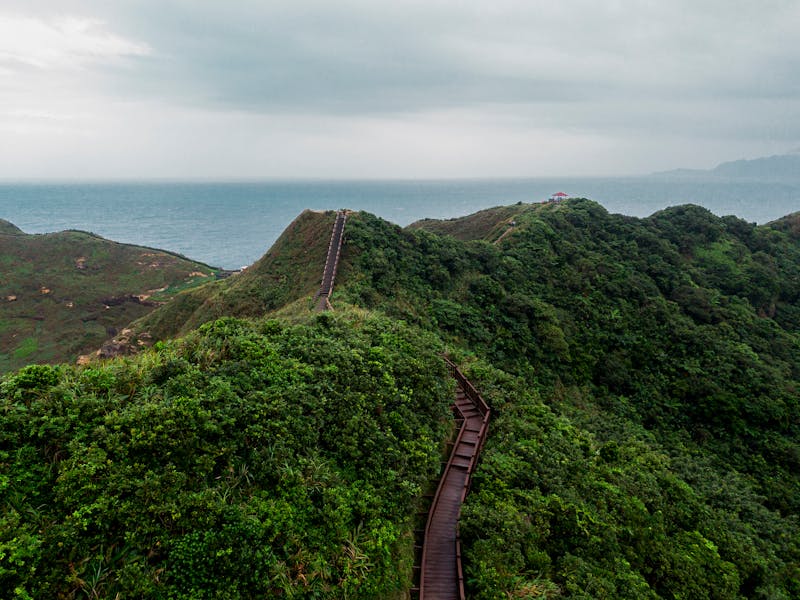 A breathtaking aerial view over the lush green Bitoujiao Trail in Ruifang District, New Taipei City, Taiwan.